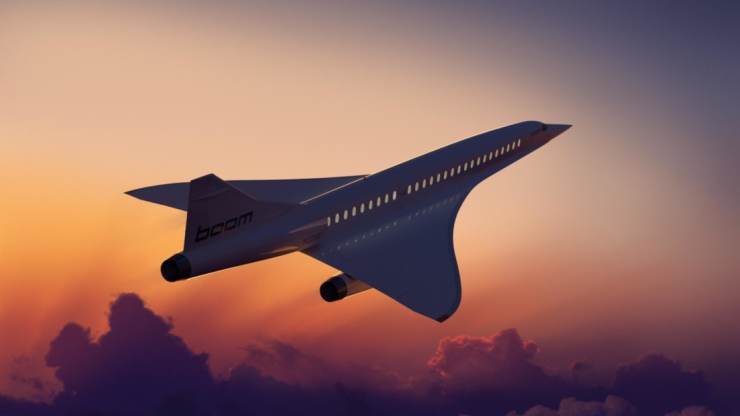 Boom Supersonic aircraft flying into the sunset.